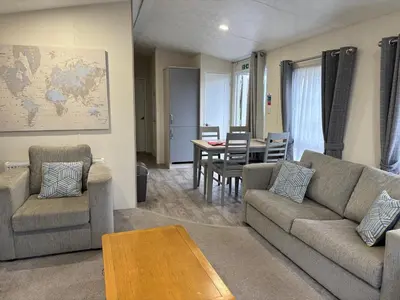 a living room with a couch and a table at Forestbrook - Cheerful two bedroom tiny house in Carlisle