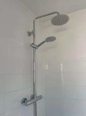 a shower with a glass door in a bathroom at Birks road in Cleator Moor