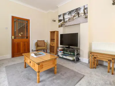 a living room with a tv and a coffee table at Melbreak House 2 in Keswick