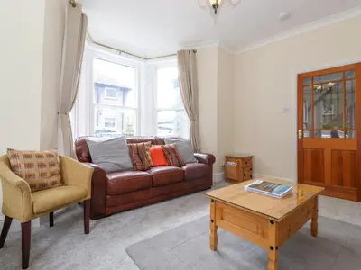 a living room with a brown couch and a coffee table at Melbreak House 2 in Keswick