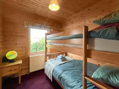 a bedroom with two bunk beds in a cabin at Bengairn in Ringford