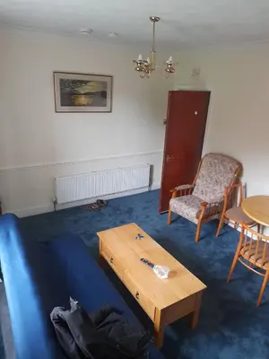 a living room with a couch and a table and a chair at Smriti's in Dumfries