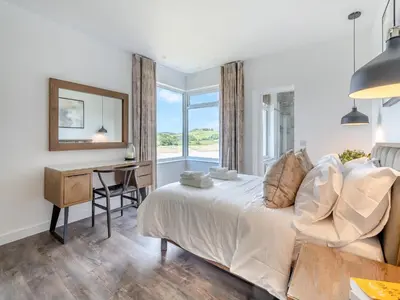 a bedroom with a bed and a desk and a window at Berkeley in Kippford