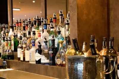 a bar filled with lots of bottles of alcohol at Keswick Country House Hotel in Keswick