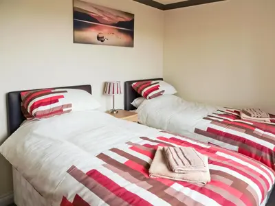 two beds sitting next to each other in a bedroom at Firth Lodge in Mainsriddle