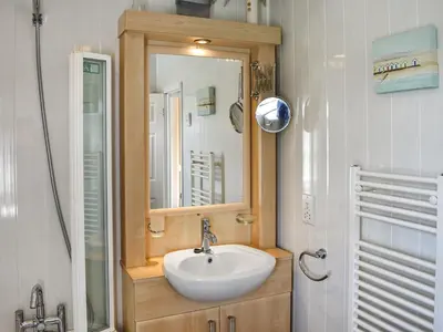 a bathroom with a sink and a mirror at Meadows Lodge - Uk46825 in Plumbland