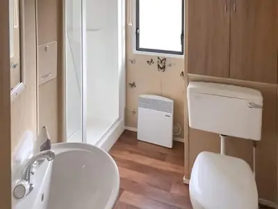 a bathroom with a white toilet and a sink at Merse Place 57- Uk46905 in Mainsriddle