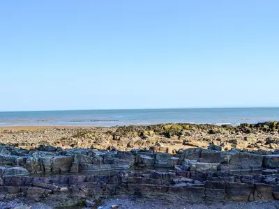 a rocky beach with the ocean in the background at Merse Place 57- Uk46905 in Mainsriddle