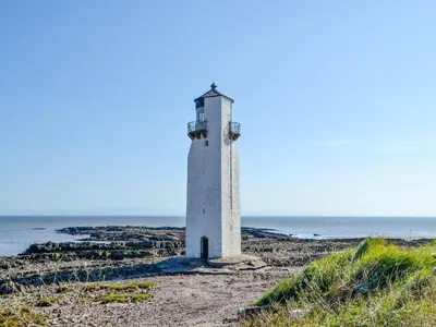 a lighthouse on the shore of the ocean at Merse Place 57- Uk46905 in Mainsriddle