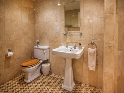a bathroom with a toilet and a sink at The Bothy in Ivegill