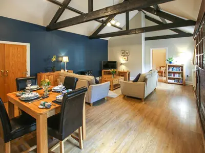 a living room with a table and a dining room at The Bothy in Ivegill