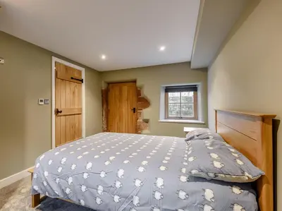 a bedroom with a bed with a blue comforter at 2 Bed in Dalston 93820 in Dalston