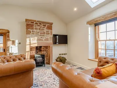 a living room with two leather couches and a fireplace at 2 Bed in Dalston 93820 in Dalston