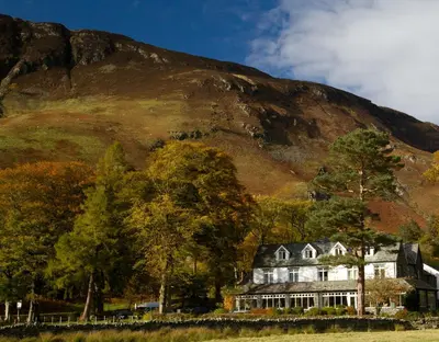 a large house in front of a mountain at Borrowdale Gates Hotel in Keswick