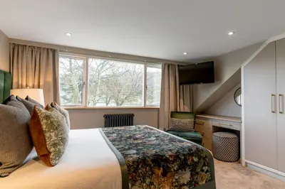 a hotel room with a bed and a window at Borrowdale Gates Hotel in Keswick