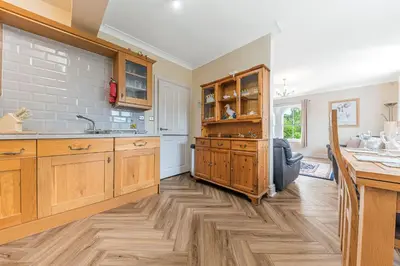 a kitchen with wooden cabinets and a wooden floor at Stickle Tarn in Keswick