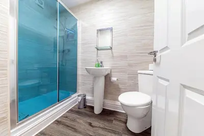a bathroom with a toilet and a glass shower at Stickle Tarn in Keswick
