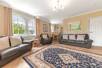 a living room with a couch and chairs and a rug at Stickle Tarn in Keswick