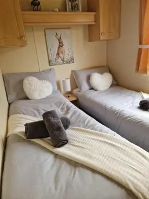 two beds in a room with stuffed animals on them at Lochview Retreat Caravan in Balminnoch