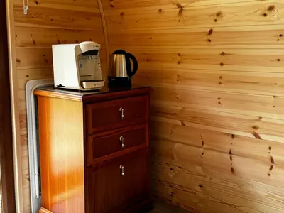 a coffee maker sitting on top of a wooden cabinet at Howbeck Lodge in Hesket Newmarket