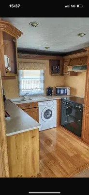 a kitchen with a stove and a white appliance at Turnberry Holiday Park in Turnberry