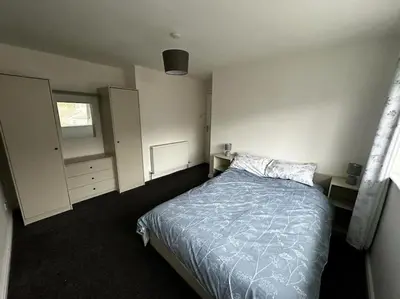 a small bedroom with a bed and a window at Large 3 bed property in Whitehaven