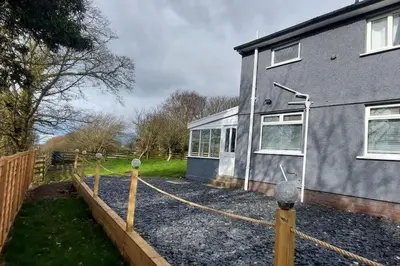 a house with a fence and a house at Large 3 bed property in Whitehaven