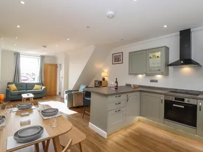 a kitchen and living room with a table and a dining room at 2 South Street in Wigton