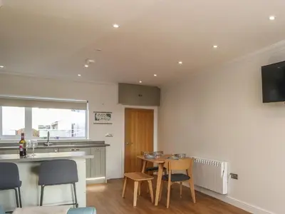 a kitchen and dining room with a table and chairs at 2 South Street in Wigton