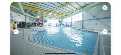 a large swimming pool with water in a building at Robinson retreats beautiful caravan with sea views pet friendly in Mainsriddle