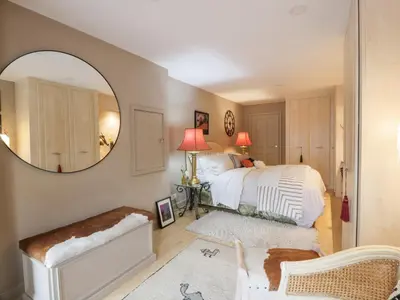 a bedroom with a bed and a large mirror at Scotia At The Pow in Annan