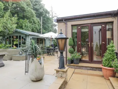 a patio with plants and a street light at Scotia At The Pow in Annan