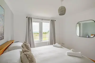 a bedroom with a bed and a window at Berryrigg Cottage in Dumfries