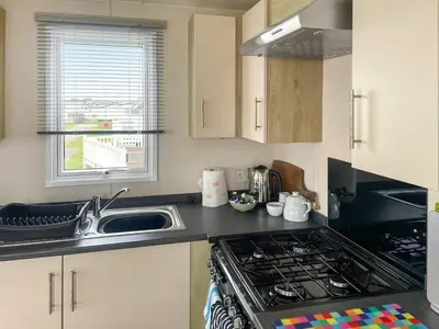 a kitchen with a sink and a stove top oven at Seaview 61-Uk46904 in Mainsriddle