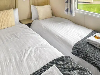 two beds in a small room with a window at Seaview 61-Uk46904 in Mainsriddle