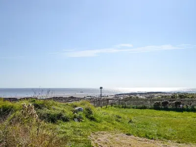 a beach with the ocean in the background at Seaview 61-Uk46904 in Mainsriddle