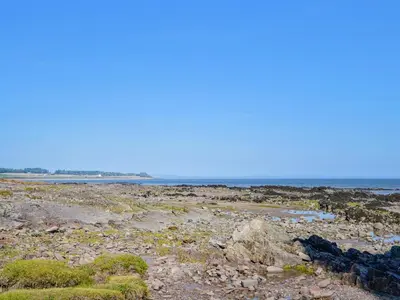 a rocky beach with the ocean in the background at Seaview 61-Uk46904 in Mainsriddle