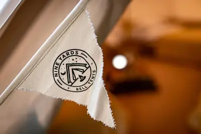a close up of a napkin with a logo on it at Nine Yards Bell Tents at the TT - Douglas in Douglas