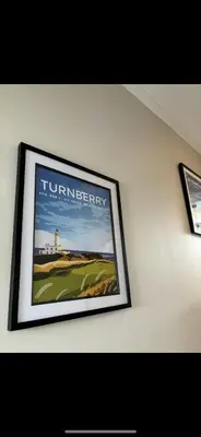 a picture hanging on a wall in a room at Golfers Rest in Ayr