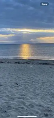 a sandy beach with the ocean in the background at Golfers Rest in Ayr