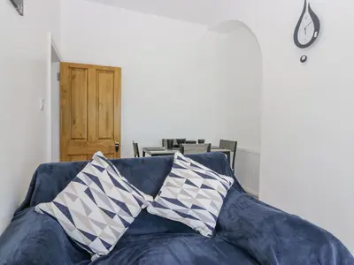 a blue couch with two pillows on top of it at Victroneen Cottage in Whitehaven