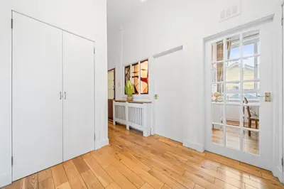 an empty living room with white walls and wood floors at Perfect location for beach and golfing in Troon