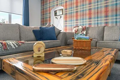 a living room with a couch and a wooden coffee table at Royal Troon Golf Let in Troon