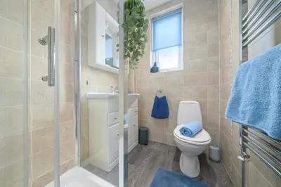 a bathroom with a toilet and a sink and a shower at Royal Troon Golf Let in Troon