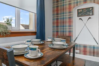 a wooden table with cups and saucers on it at Royal Troon Golf Let in Troon