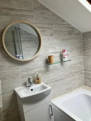 a bathroom with a sink and a mirror at Annie's Cottage in Gosforth