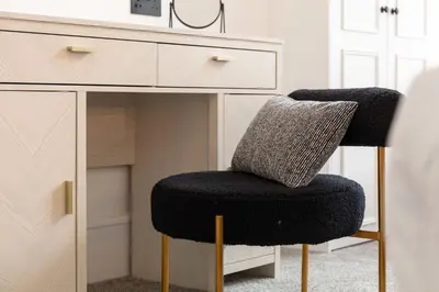 a black chair sitting next to a desk at Wellington Lodge in Ayr