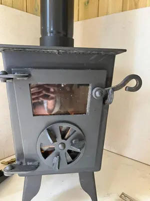 a stove with a wheel inside of it at Wee Beach Hut Maidens in Maidens