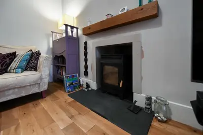 a living room with a fireplace and a couch at Arran View in Prestwick in Prestwick
