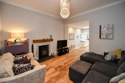 a living room with a couch and a fireplace at Arran View in Prestwick in Prestwick